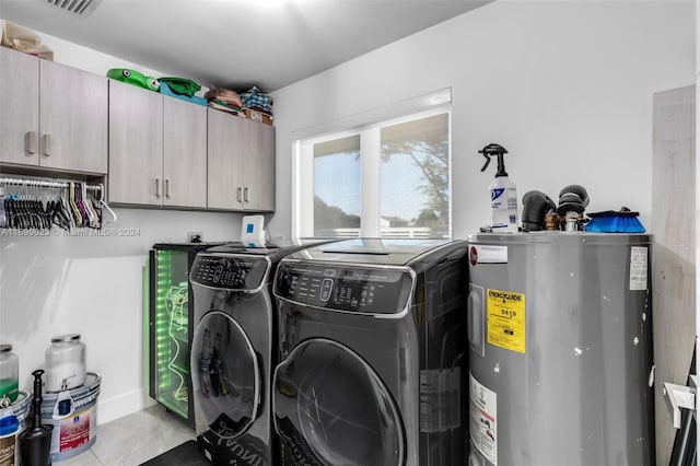 washroom with independent washer and dryer, cabinets, and electric water heater