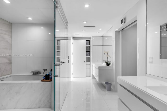 10 SW 124th Ave, Miami, FL 33184 - full bathroom with vanity, a garden tub, and marble tiled flooring