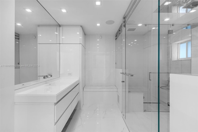 bathroom featuring vanity and a shower with door