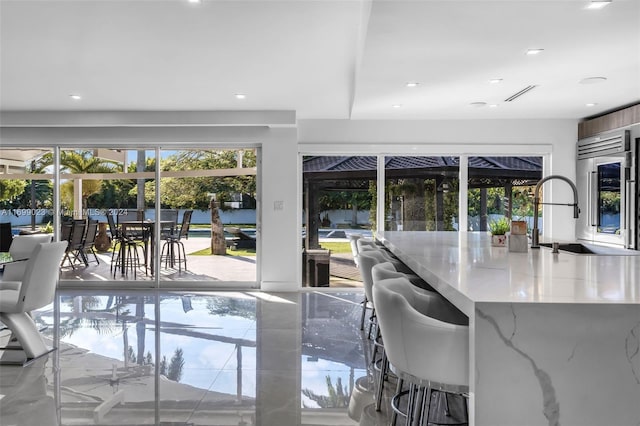 interior space featuring wine cooler, plenty of natural light, and sink