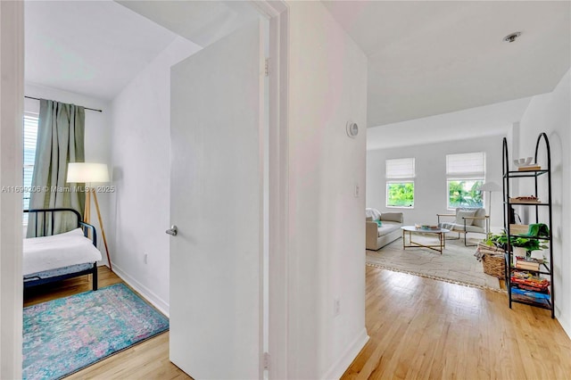 corridor with light hardwood / wood-style floors