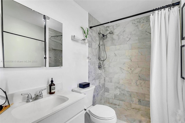 bathroom featuring toilet, vanity, and a shower with curtain