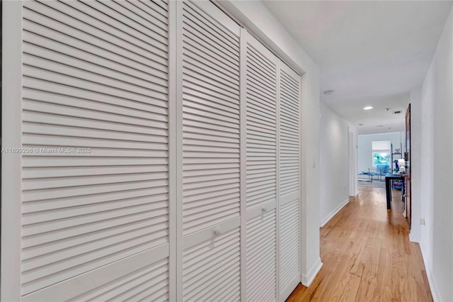 hallway with light hardwood / wood-style floors