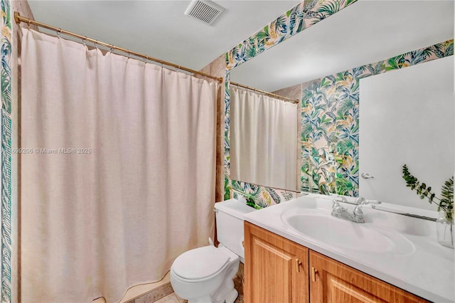 802 Euclid Ave Unit 302, Miami Beach, FL 33139 - bathroom featuring visible vents, wallpapered walls, vanity, and toilet