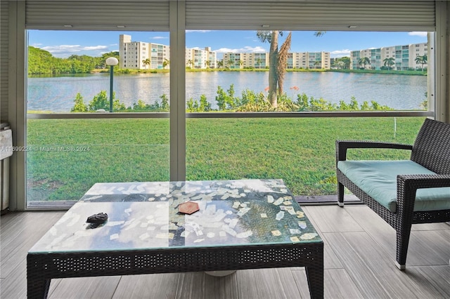 sunroom with a water view and plenty of natural light