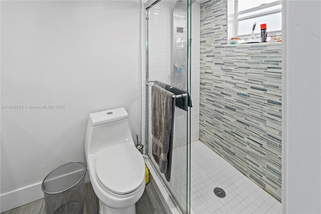 bathroom with an enclosed shower and toilet