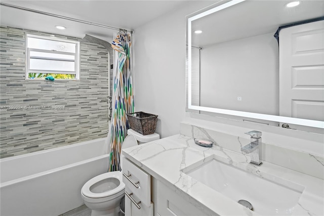 full bathroom with vanity, toilet, and shower / bath combo with shower curtain