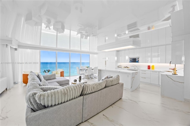 16445 Collins Ave Unit 1126, Sunny Isles Beach, FL 33160 - living area featuring a water view, a high ceiling, and light marble finish floors