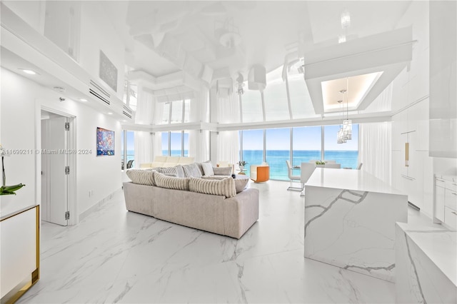 16445 Collins Ave Unit 1126, Sunny Isles Beach, FL 33160 - living area featuring a water view, a towering ceiling, and light marble finish flooring