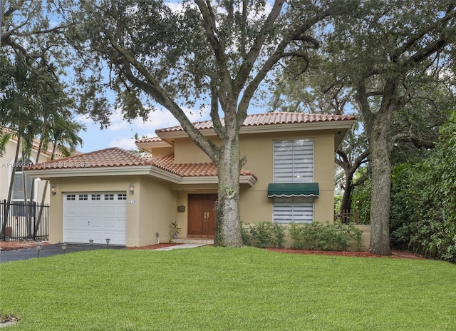 view of front facade with a garage and a front lawn