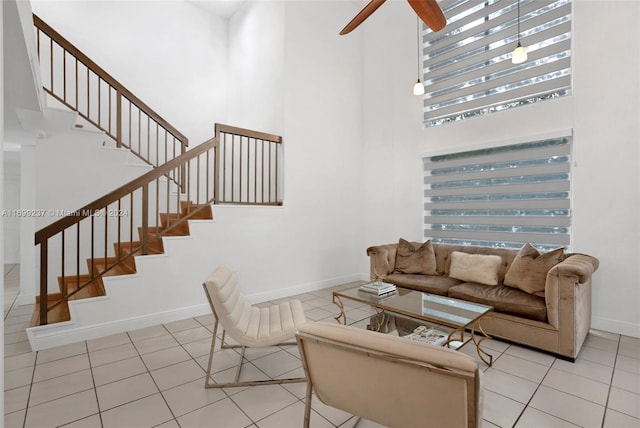 living room featuring a high ceiling and light tile patterned floors