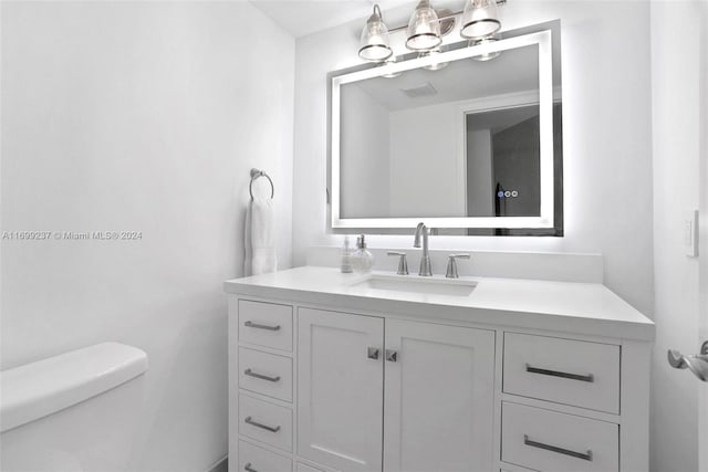 bathroom featuring vanity and toilet