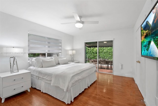 bedroom featuring access to exterior, ceiling fan, hardwood / wood-style floors, and multiple windows