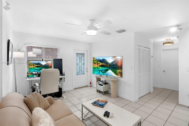 tiled living room featuring ceiling fan