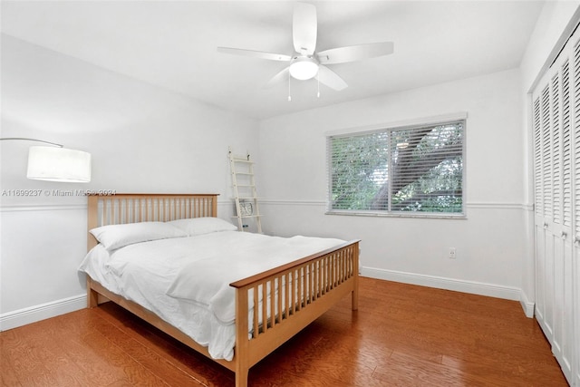 bedroom with ceiling fan, a closet, and wood-type flooring