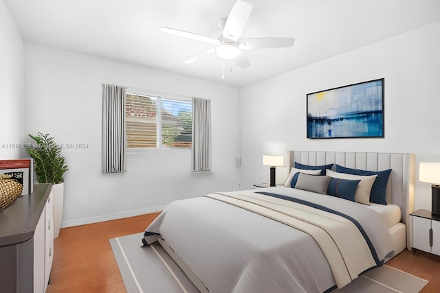 bedroom featuring light wood-type flooring and ceiling fan