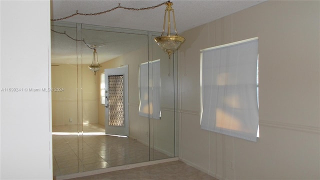 bathroom featuring tile patterned floors and a textured ceiling