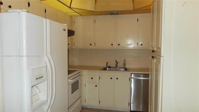 kitchen featuring white appliances and sink