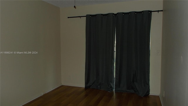 unfurnished room featuring hardwood / wood-style flooring