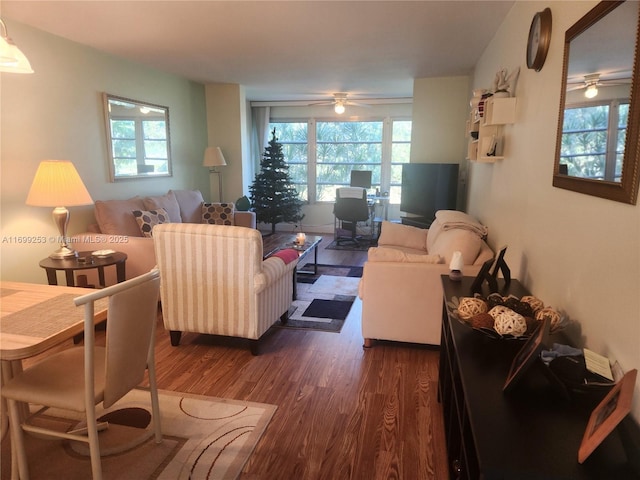 living room featuring dark wood-type flooring and ceiling fan