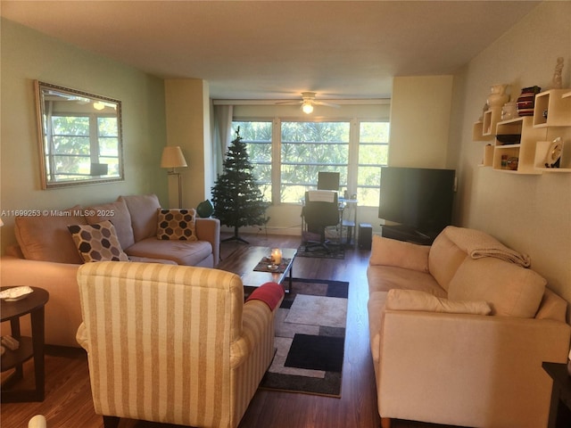 living room with dark wood-type flooring and ceiling fan