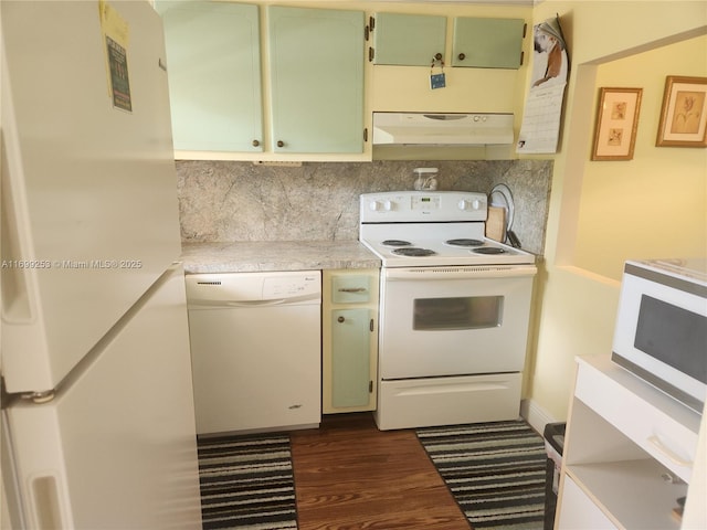 kitchen featuring white appliances, dark hardwood / wood-style floors, decorative backsplash, and green cabinets