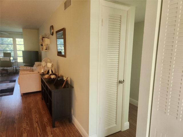 corridor with dark hardwood / wood-style floors