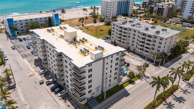 birds eye view of property with a water view and a view of the beach