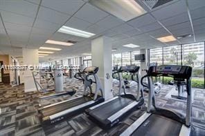 workout area with a paneled ceiling