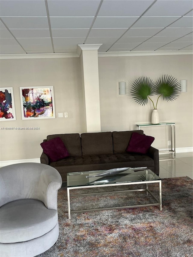 living room featuring a paneled ceiling and ornamental molding