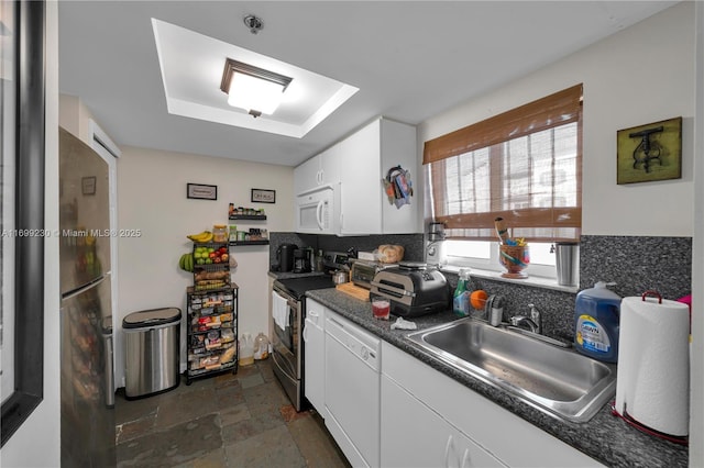 kitchen featuring appliances with stainless steel finishes, sink, and white cabinets