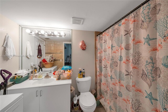 bathroom featuring vanity, a shower with shower curtain, and toilet