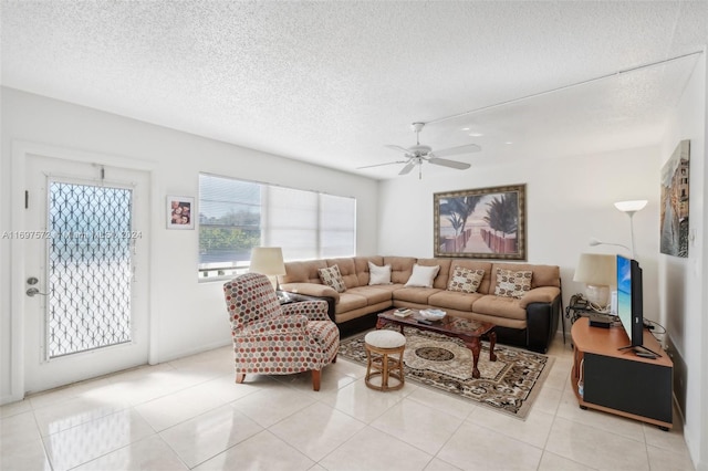 tiled living room featuring ceiling fan and a textured ceiling