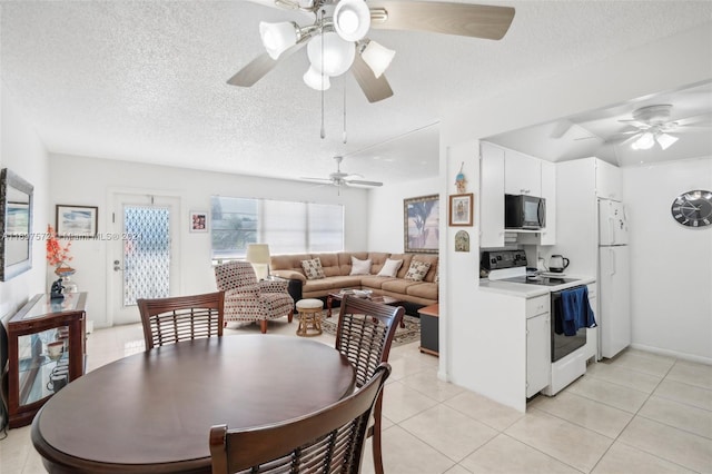 dining area featuring light tile patterned flooring and a textured ceiling