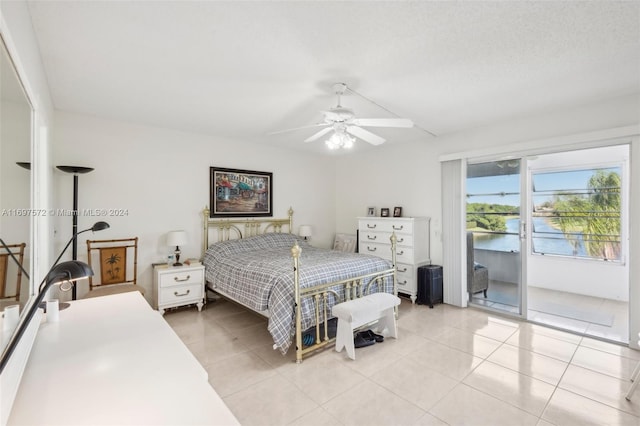 tiled bedroom with ceiling fan, access to exterior, and a water view