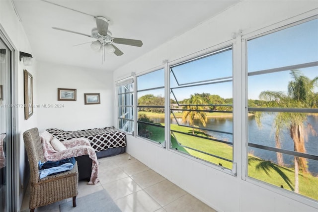 sunroom featuring a water view and ceiling fan