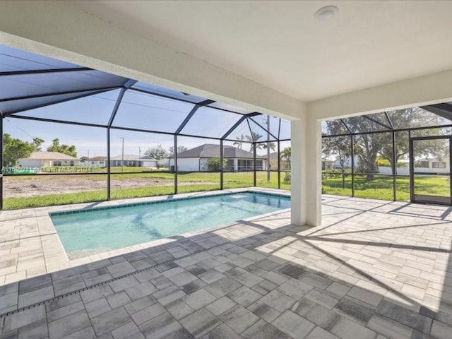 view of pool featuring a lawn, a lanai, and a patio