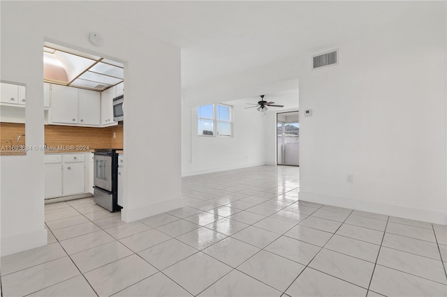 unfurnished living room featuring ceiling fan and light tile patterned flooring