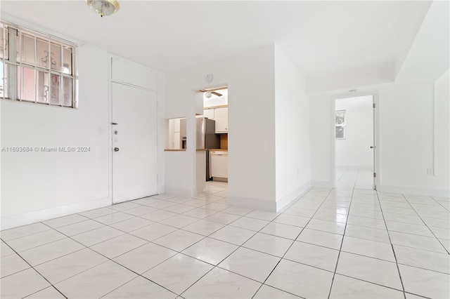 spare room featuring light tile patterned flooring