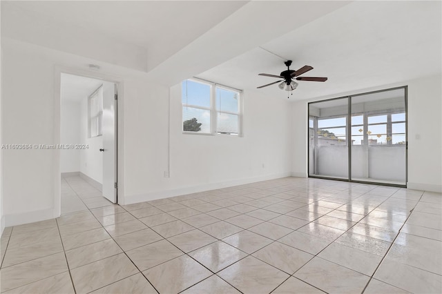 unfurnished room featuring ceiling fan and light tile patterned flooring