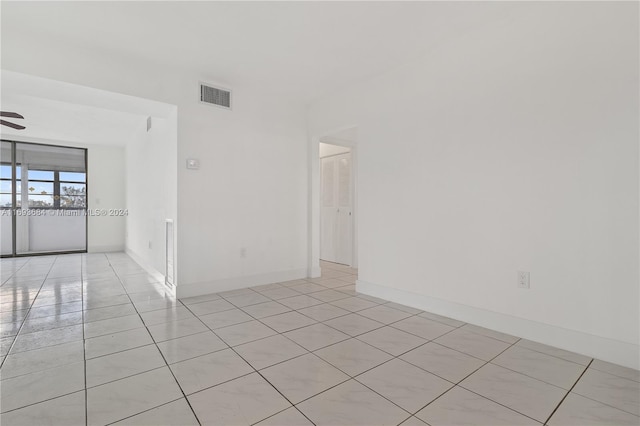 tiled empty room with ceiling fan