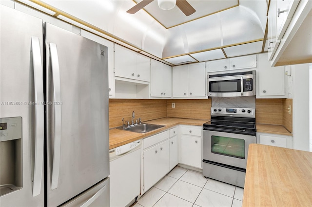 kitchen featuring white cabinetry, sink, ceiling fan, stainless steel appliances, and light tile patterned floors