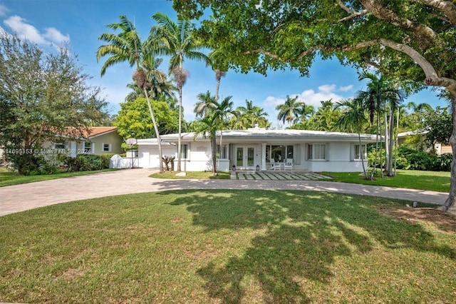 single story home featuring french doors, a front lawn, and a porch