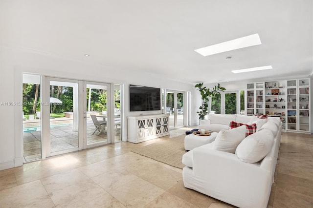 living room featuring a skylight and french doors