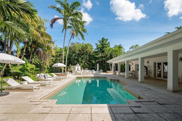 view of pool with french doors and a patio