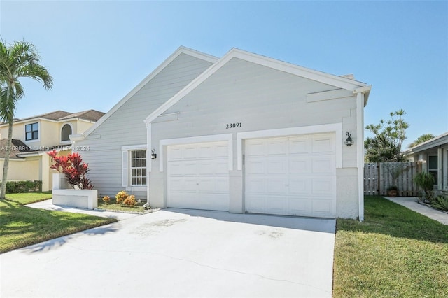 view of front of house featuring a front lawn and a garage