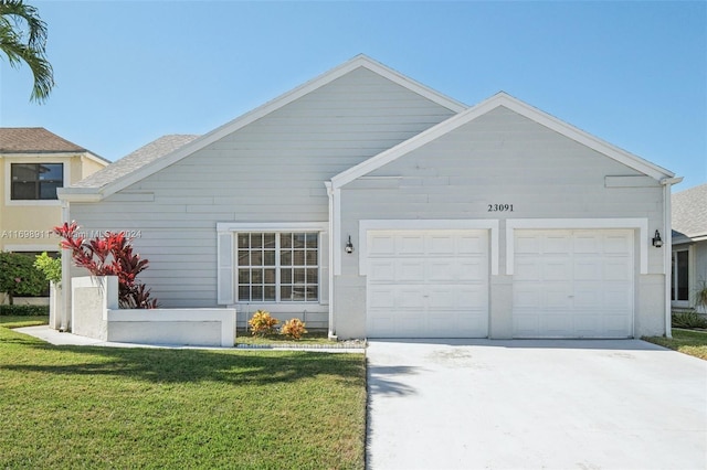 view of front of property featuring a garage and a front lawn