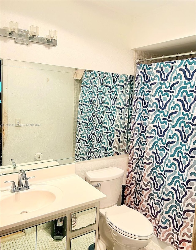 bathroom with tile patterned floors, vanity, and toilet