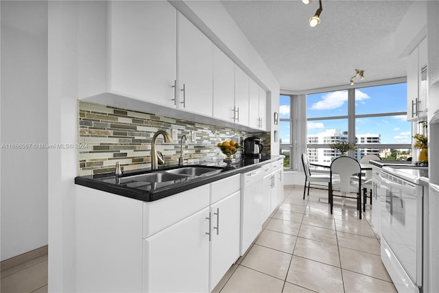 kitchen featuring a textured ceiling, white appliances, white cabinetry, and sink