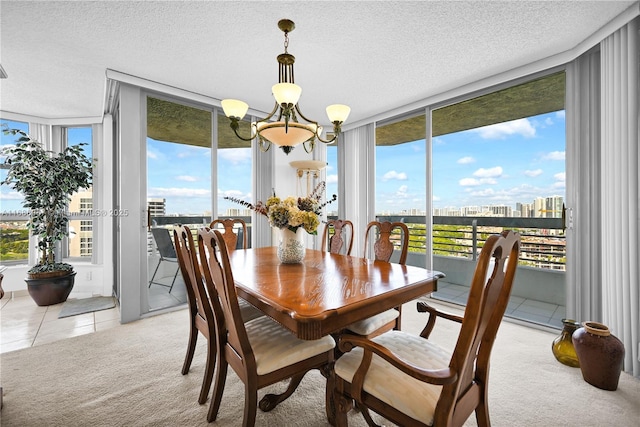 dining space featuring light colored carpet, an inviting chandelier, expansive windows, a textured ceiling, and a city view